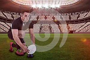 Composite image of rugby player getting ready to kick ball with 3d