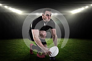 Composite image of rugby player getting ready to kick ball