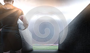 Composite image of rugby player holding the ball