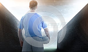 Composite image of rugby player holding a rugby ball