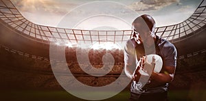 Composite image of rugby player looking away while catching ball 3D