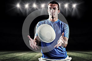 Composite image of rugby player trying to catch the ball