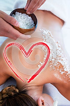 Composite image of salt scrub massage with love heart