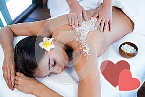 Composite image of salt scrub massage with love hearts