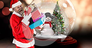 Composite image of santa claus carrying christmas gifts with snow globe in background