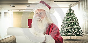 Composite image of santa claus checking his list