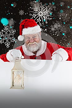 Composite image of santa claus holding christmas lantern