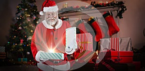 Composite image of santa claus opening gift box