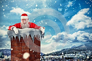 Composite image of santa claus peeking over wall