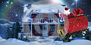 Composite image of santa claus riding on sled with gift box