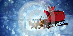 Composite image of santa claus riding on sleigh with gift box