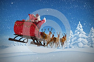 Composite image of santa claus riding on sleigh with gift box