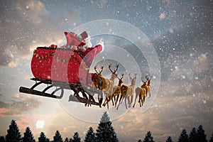 Composite image of santa claus riding on sleigh with gift box