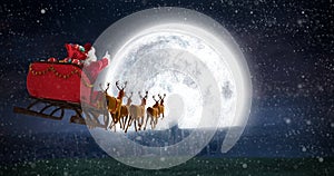 Composite image of santa claus riding on sleigh with gift box photo