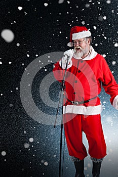 Composite image of santa claus singing christmas songs