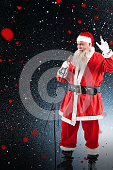 Composite image of santa claus singing christmas songs