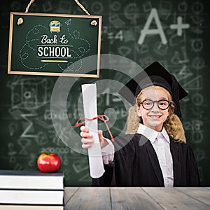 Composite image of schoolgirl with graduation robe and holding her diploma