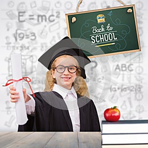 Composite image of schoolgirl with graduation robe and holding her diploma