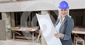 Composite image of selfassured businesswoman wearing a helmet photo