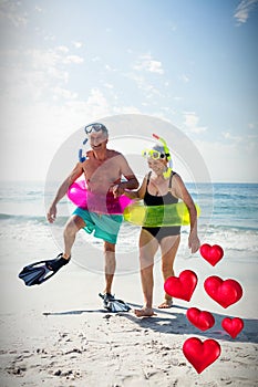 Composite image of senior couple and floating love hearts 3d