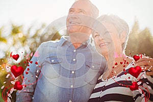 Composite image of senior couple and valentines hearts 3d