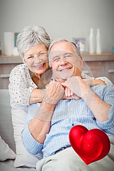 Composite image of senior couple and valentines hearts 3d