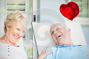 Composite image of senior couple and valentines hearts 3d