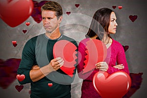 Composite image of serious couple holding cracked heart shape 3d