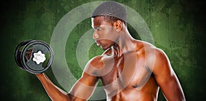 Composite image of serious fit shirtless young man lifting dumbbell