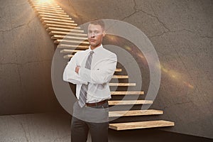 Composite image of serious manager with arms crossed in warehouse 3d