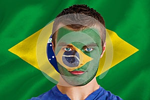 Composite image of serious young brasil fan with facepaint