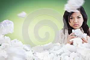 Composite image of sick woman holding a tissue and a glass of water