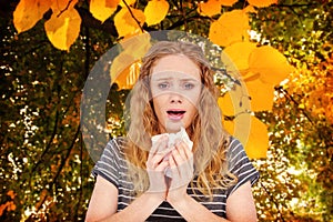 Composite image of sick woman sneezing in a tissue