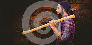 Composite image of side view of hipster with axe on shoulder