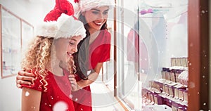 Composite image of side view of mother and daughter in christmas attire looking at jewelry display