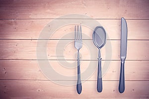 Composite image of silver knife, fork and spoon