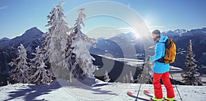 Composite image of skier with yellow backpack skiing