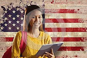 Composite image of smiling asian female student using tablet