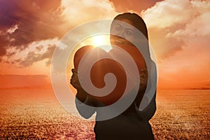 Composite image of smiling asian woman holding paper heart