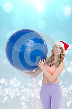 Composite image of smiling blonde woman holding exercise ball