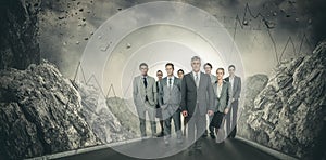 Composite image of smiling business team looking at camera