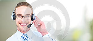 Composite image of smiling businessman with headset interacting