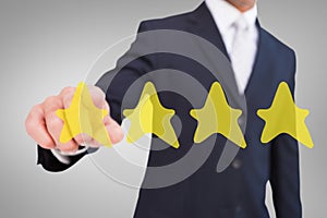 Composite image of smiling businessman in suit pointing