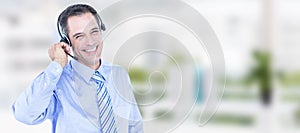 Composite image of smiling businessman using headset