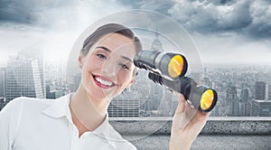 Composite image of smiling businesswoman with binoculars