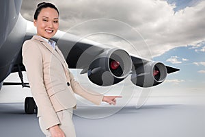 Composite image of smiling businesswoman pointing