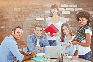 Composite image of smiling casual colleagues in a meeting