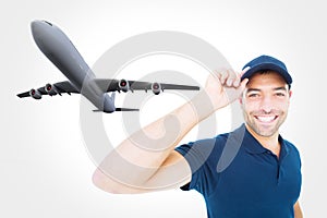 Composite image of smiling delivery man wearing cap on white background