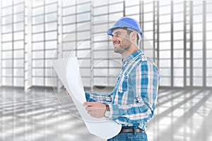 Composite image of smiling engineer looking away while holding blueprint