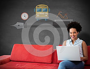 Composite image of smiling female college student using laptop while sitting on sofa